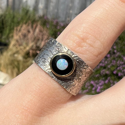 An opal and black onyx inlay ring in a sterling silver cigar-style pinkie ring.