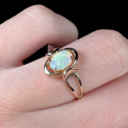 A 14 karat yellow gold open-shank design Australian crystal opal ring.