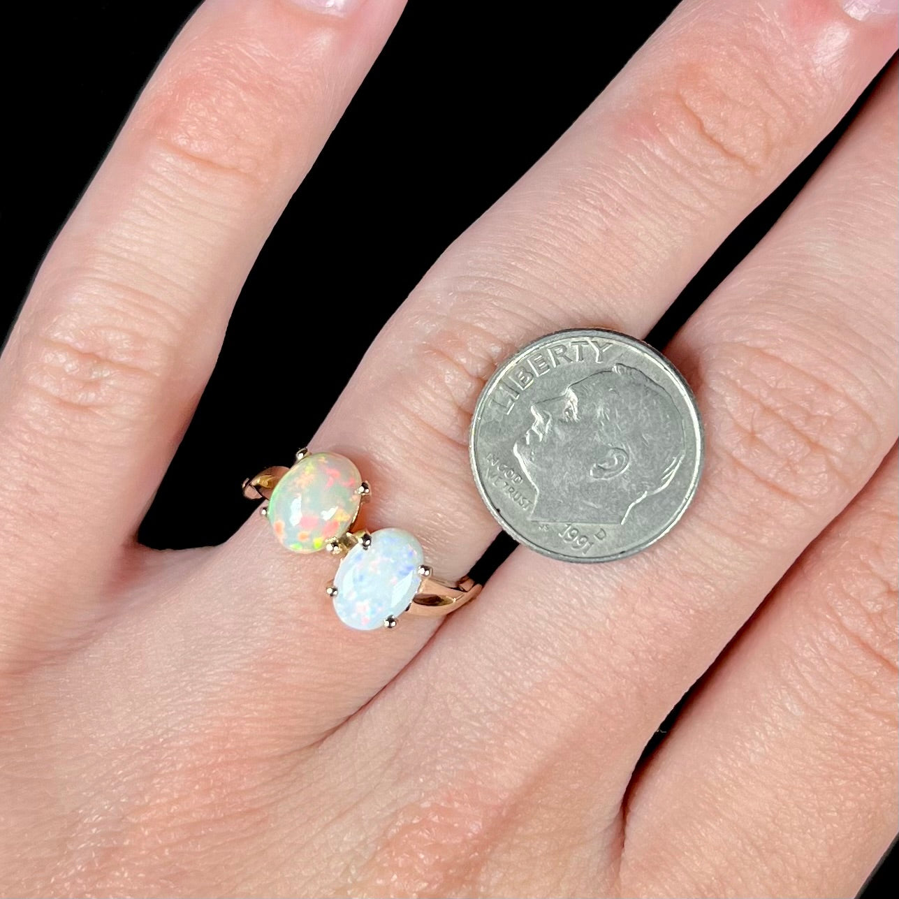 A yellow gold ring mounted with an Ethiopian fire opal and a Coober Pedy, Australian opal.