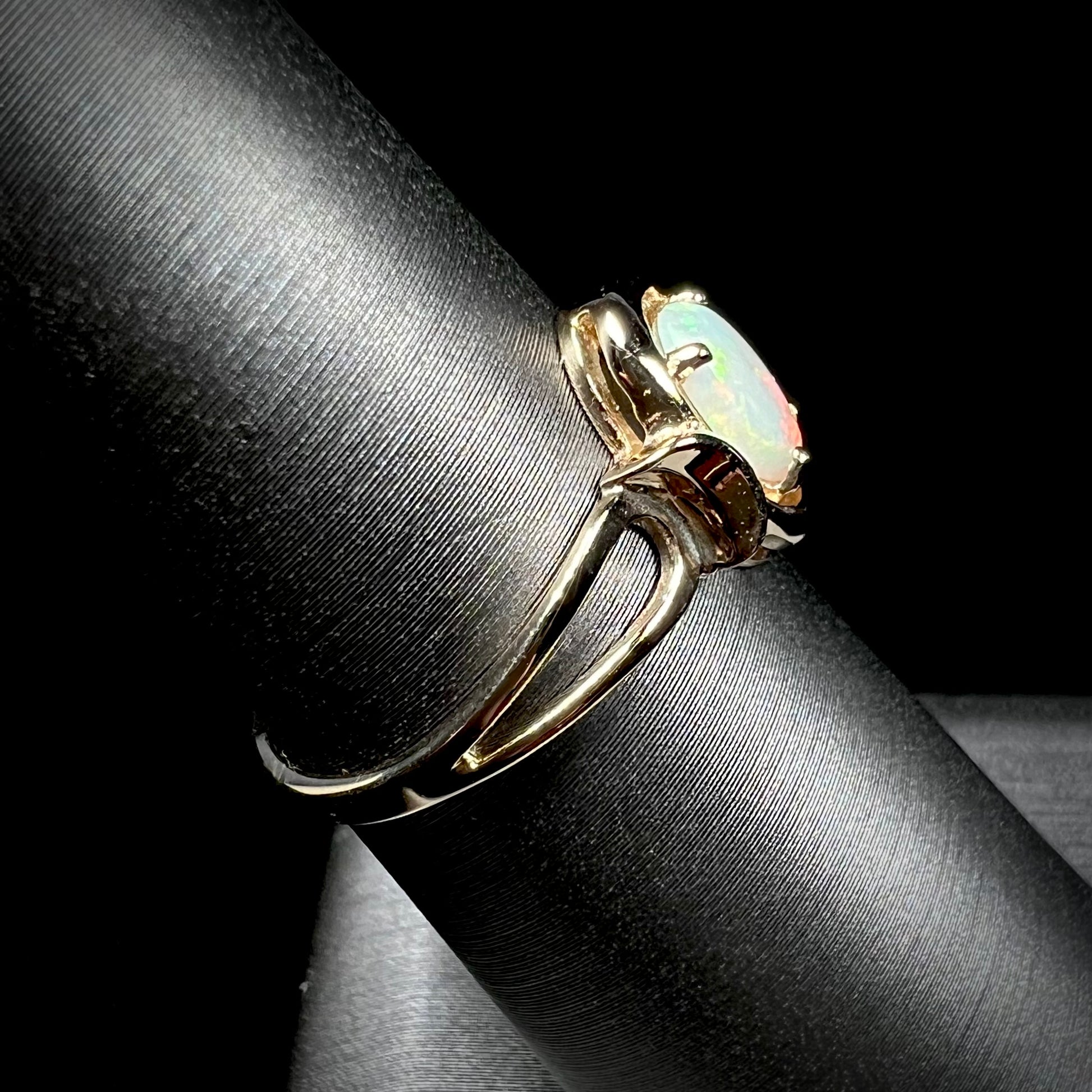 A 14 karat yellow gold open-shank design Australian crystal opal ring.