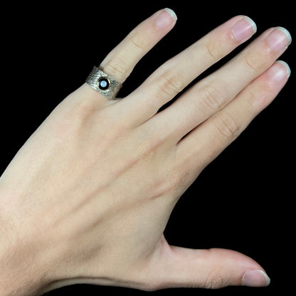 An opal and black onyx inlay ring in a sterling silver cigar-style pinkie ring.