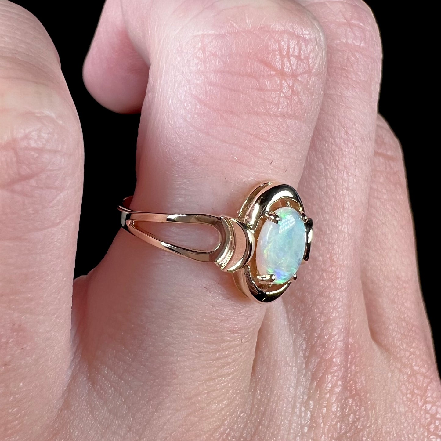 A 14 karat yellow gold open-shank design Australian crystal opal ring.