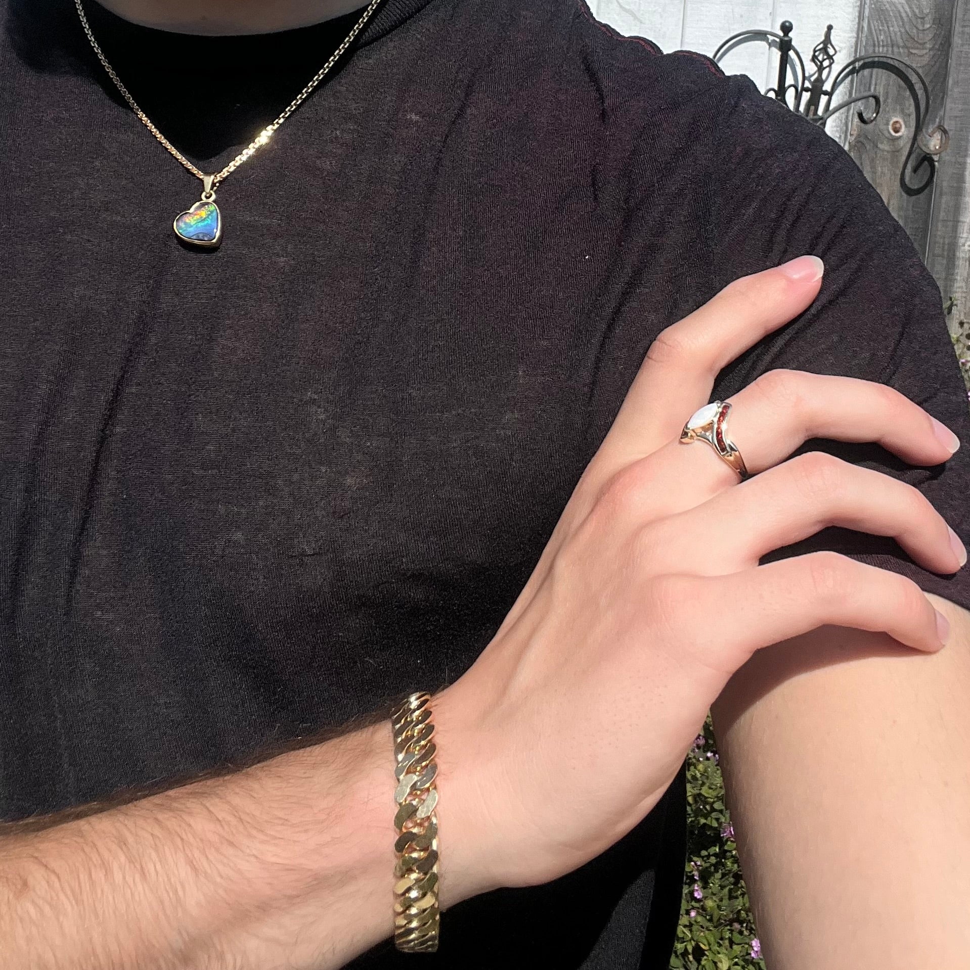 A marquise cut white opal ring.  The ring is accented with channel set reddish orange garnets.