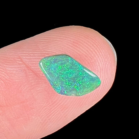 A loose, polished green opal stone from Australia.