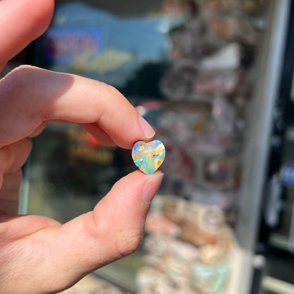 A loose, 5.90 carat heart shaped boulder opal stone from Quilpie, Australia.  The opal has blue flashes.