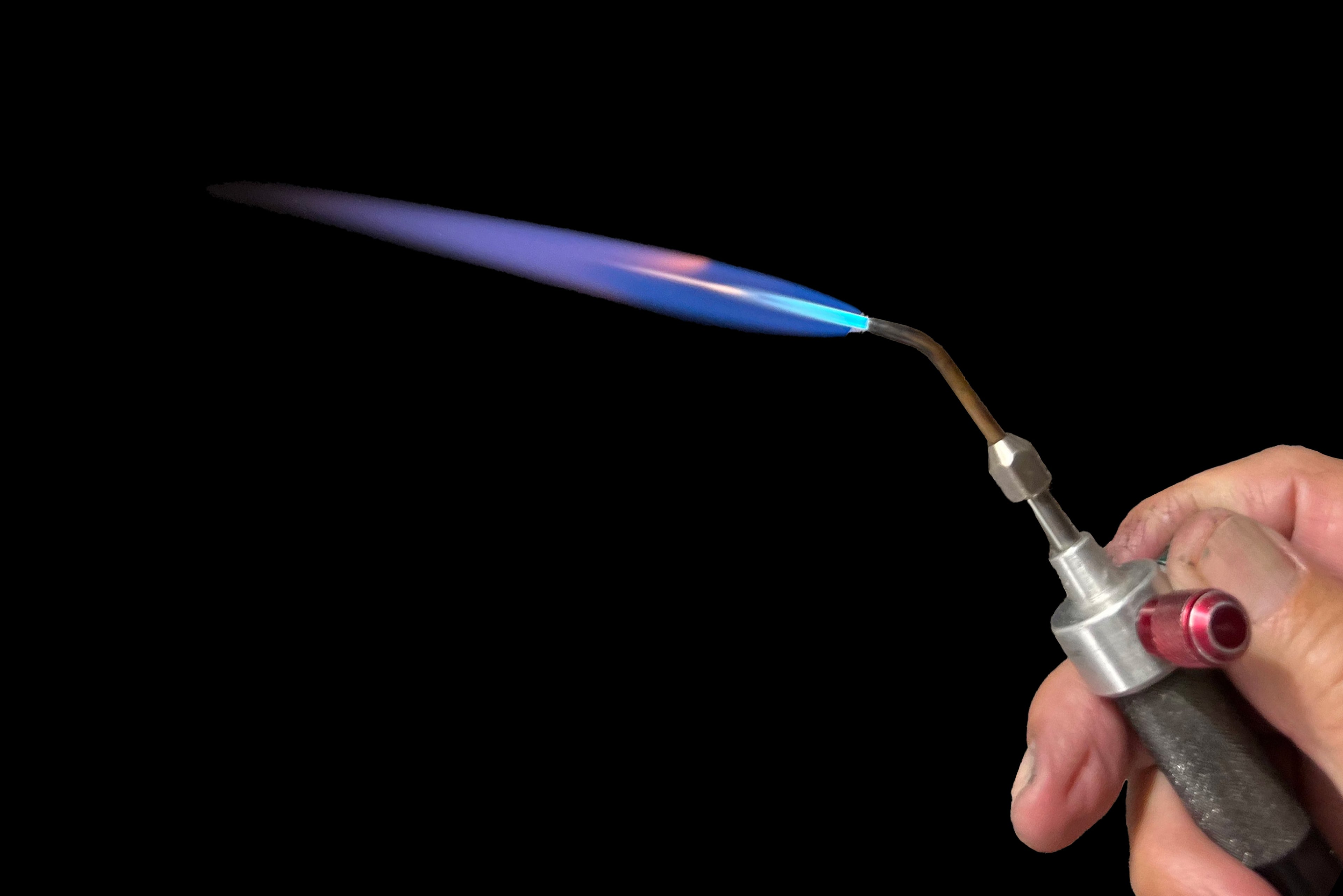 The blue flame of a jeweler's torch.