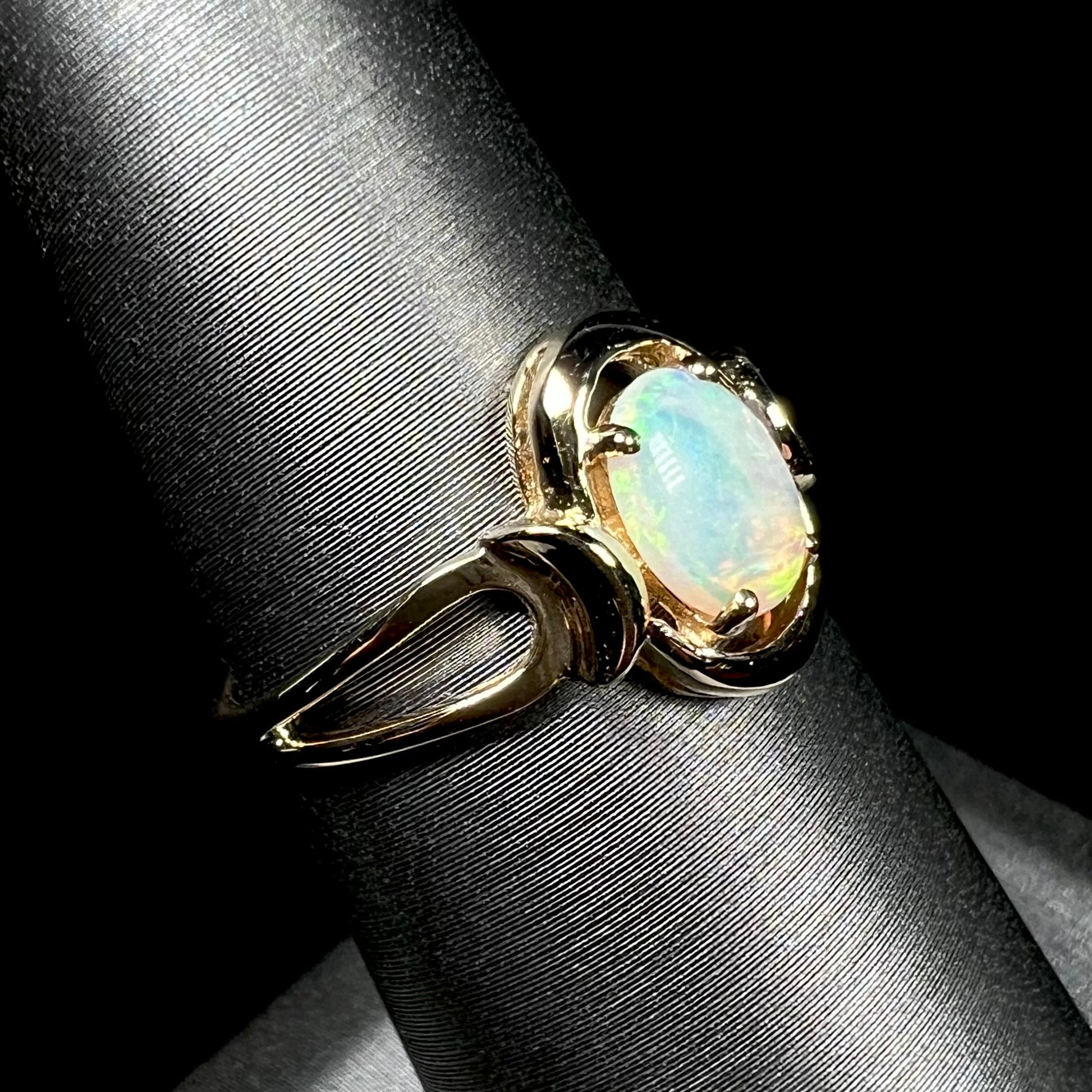 A 14 karat yellow gold open-shank design Australian crystal opal ring.