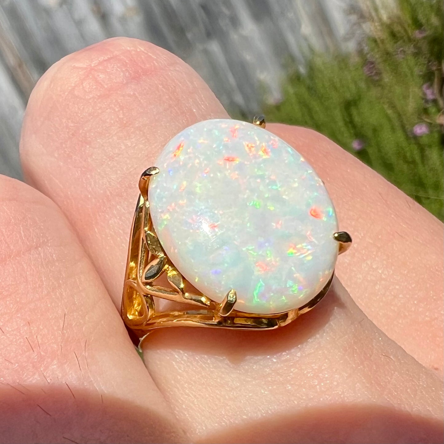 A yellow gold solitaire cocktail ring mounted with a natural white opal from Coober Pedy, Australia.