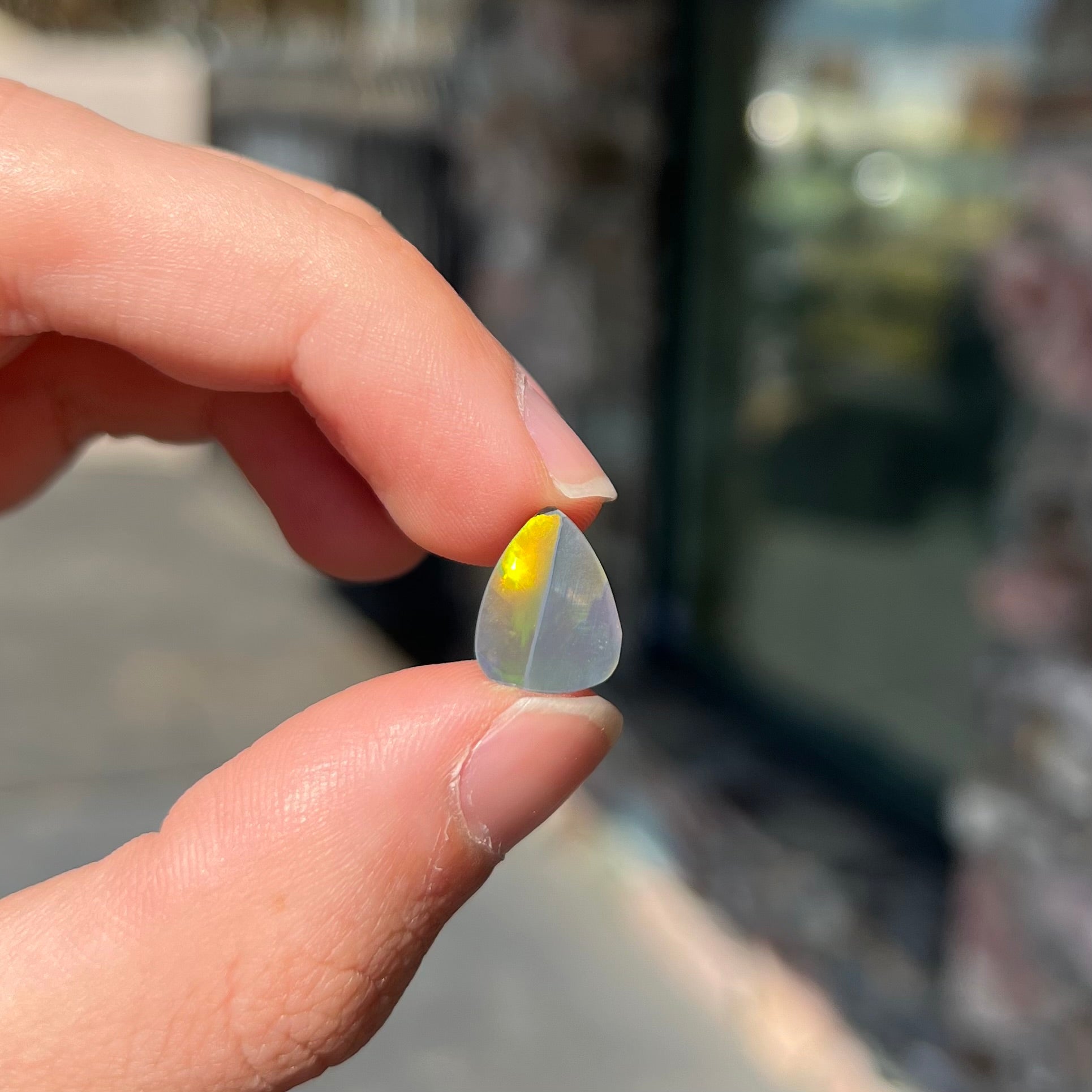 A loose, pear shaped black opal stone from Lightning Ridge, Austalia that weighs 1.19 carats.