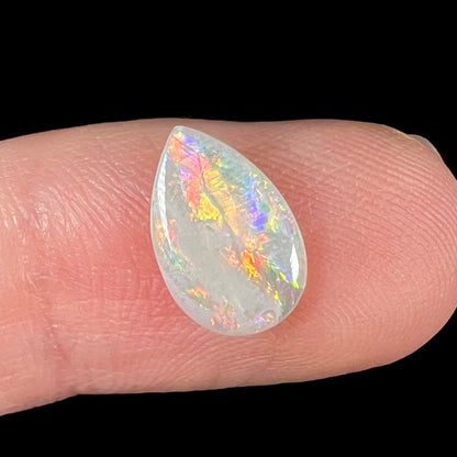 A loose, pear shaped Australian white opal stone.  The stone plays every color of the rainbow.