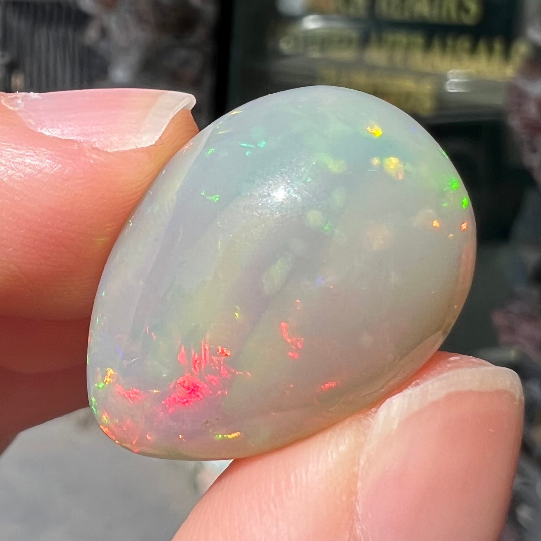 A pear shaped Ethiopian fire opal with vivid red and green play of color.