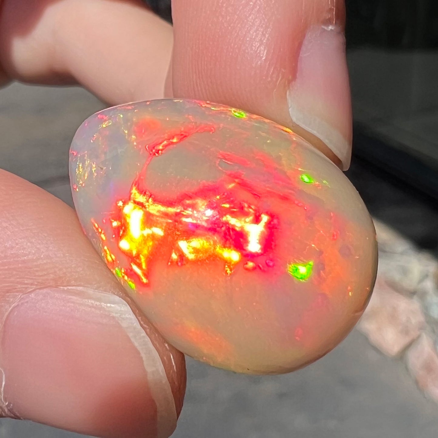 A pear shaped Ethiopian fire opal with vivid red and green play of color.