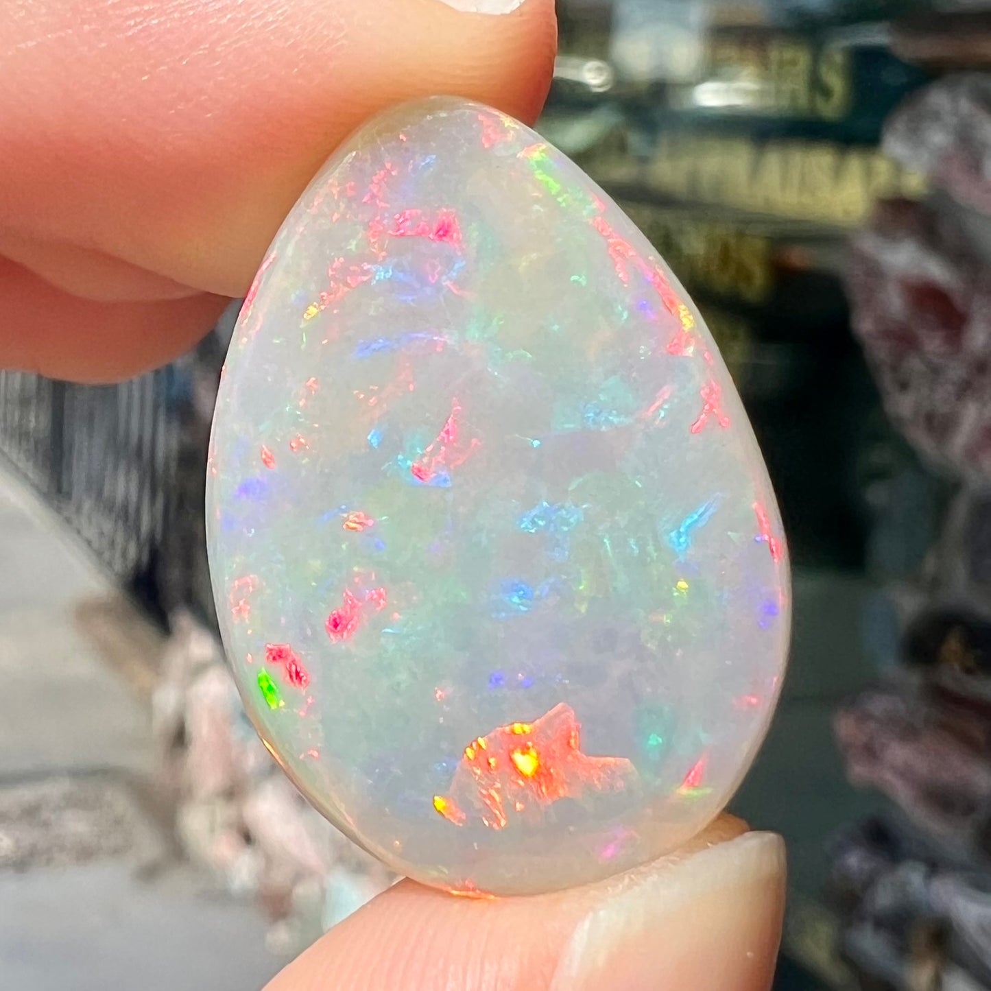 A pear shaped Ethiopian fire opal with vivid red and green play of color.