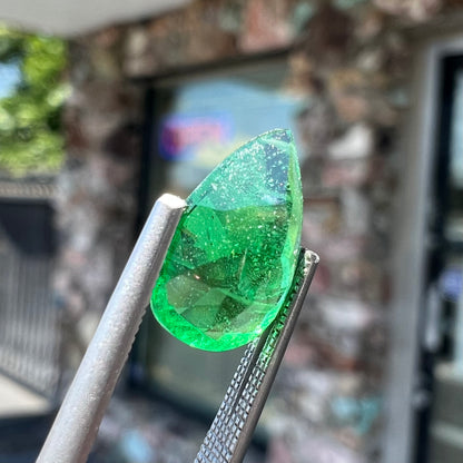 A loose, pear shaped tsavorite garnet gemstone.  The stone is vivid green color.