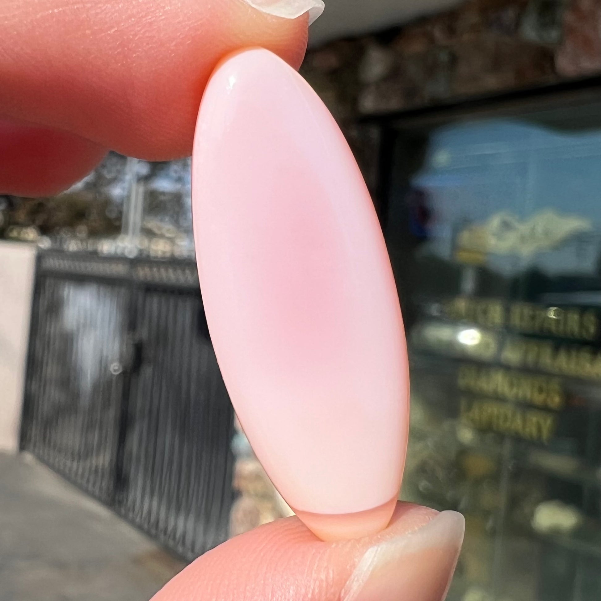 A loose, marquise cabochon cut pink common opal from Peru.  The opal has no play of color.