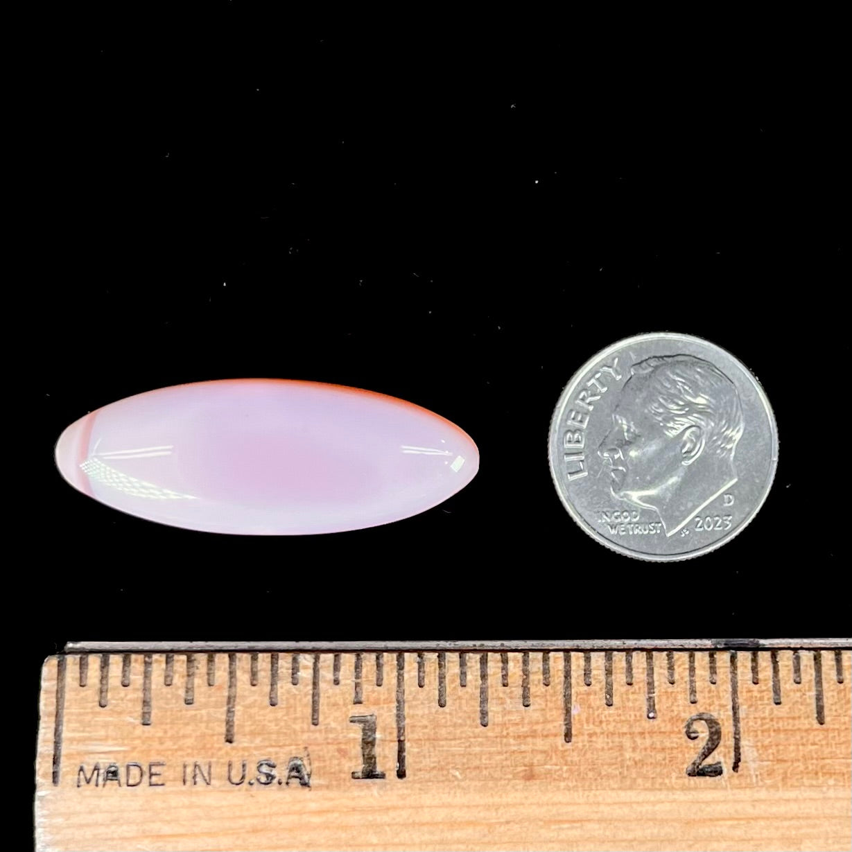 A loose, marquise cabochon cut pink common opal from Peru.  The opal has no play of color.