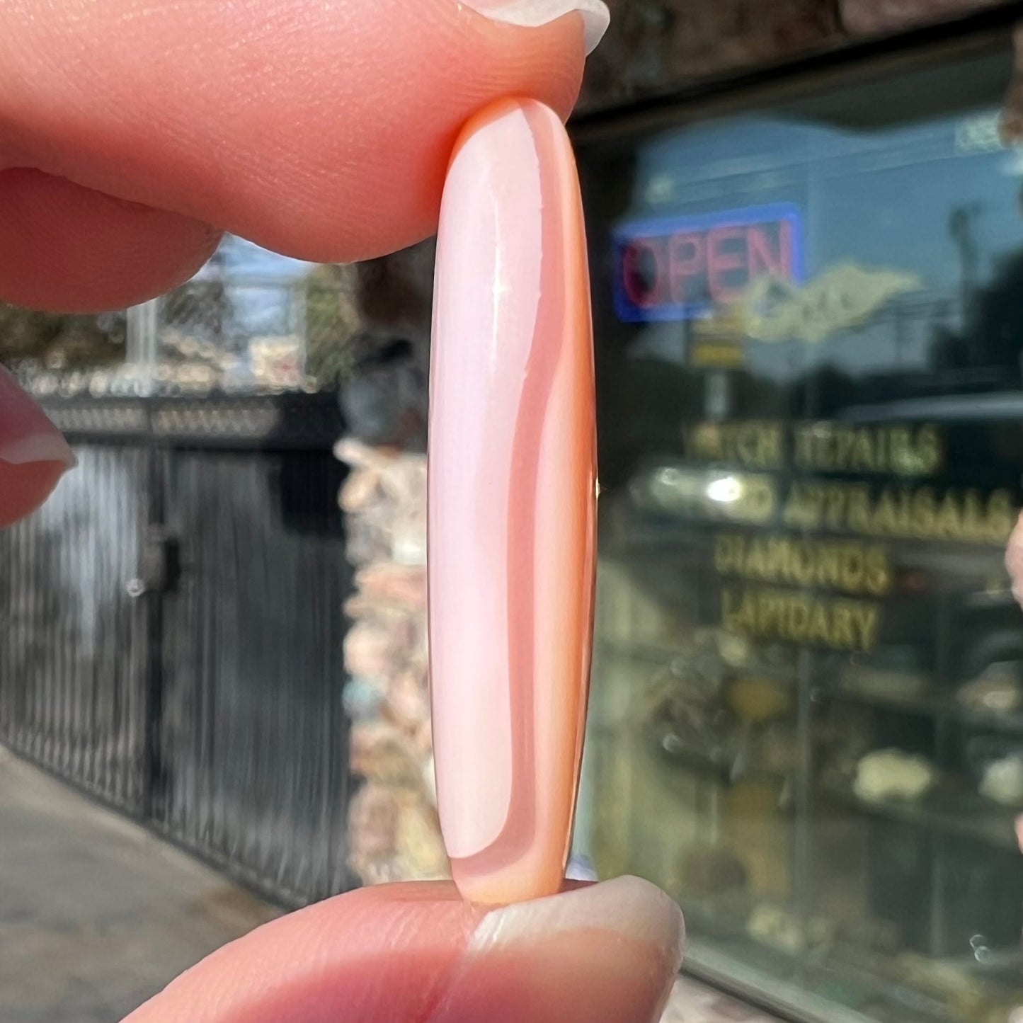 A loose, marquise cabochon cut pink common opal from Peru.  The opal has no play of color.