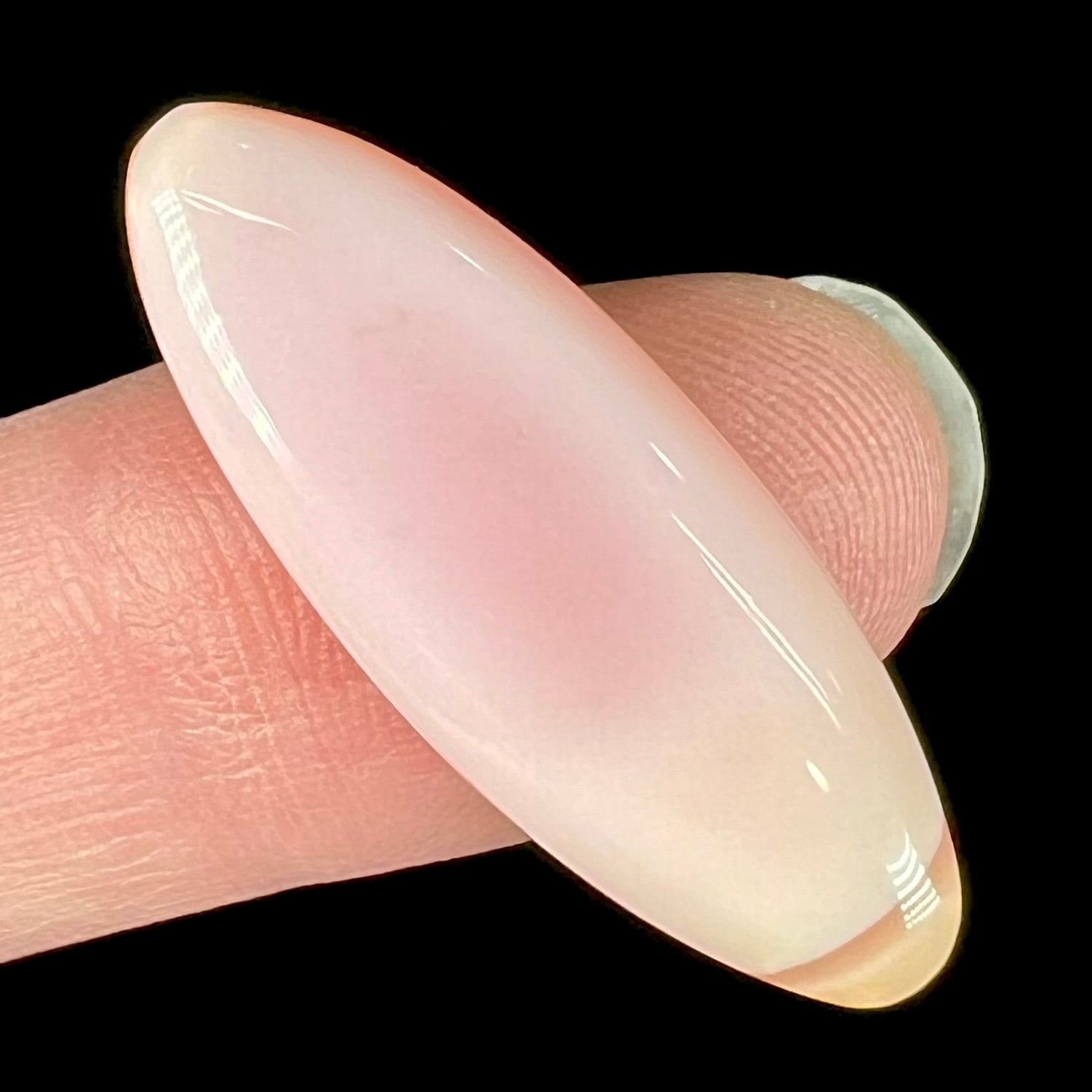 A loose, marquise cabochon cut pink common opal from Peru.  The opal has no play of color.