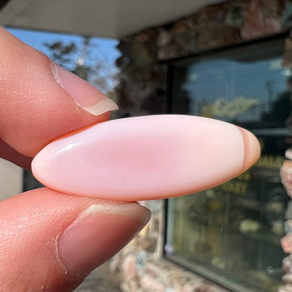 A loose, marquise cabochon cut pink common opal from Peru.  The opal has no play of color.