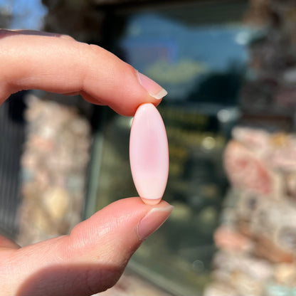 A loose, marquise cabochon cut pink common opal from Peru.  The opal has no play of color.