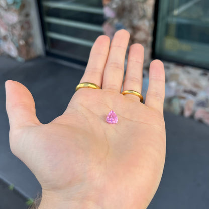 A loose, faceted trillion cut pink touramline gemstone.  The stone is a light bubblegum pink color.