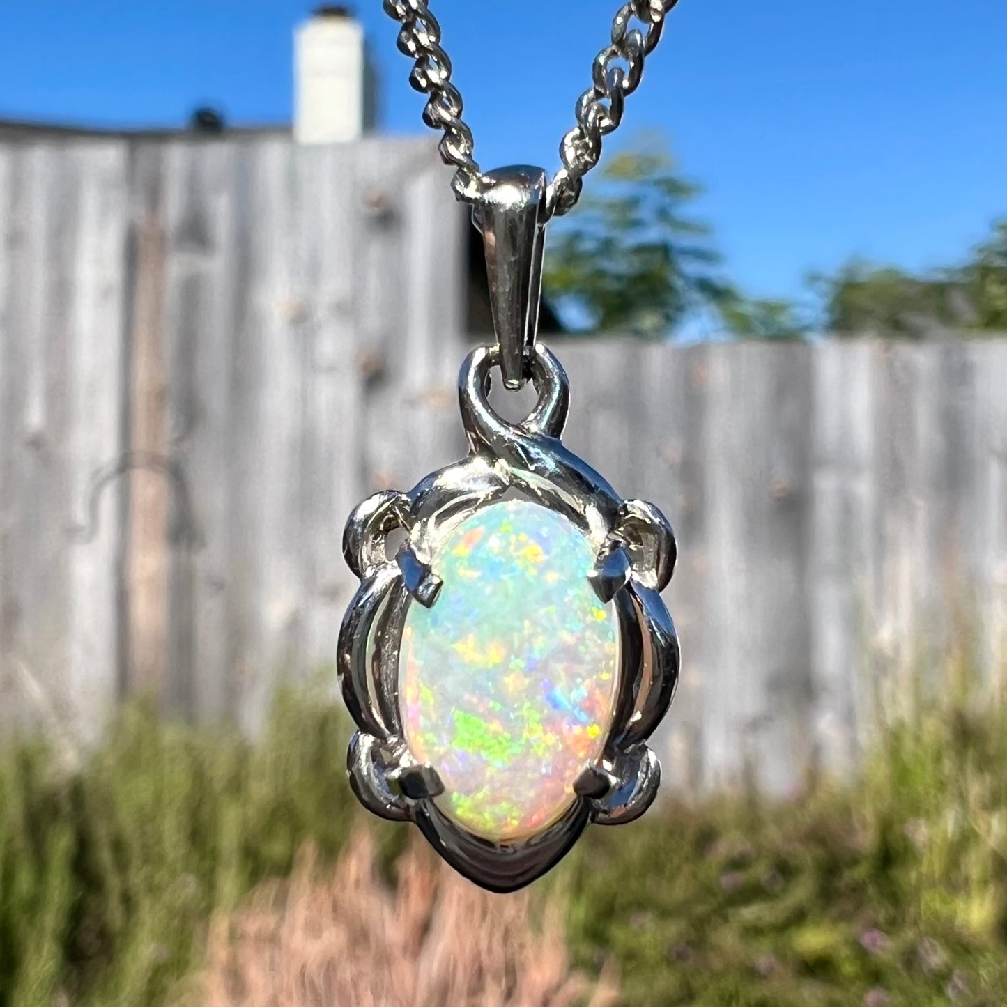 A platinum opal necklace on a platinum chain.  The opal weighs 1.49ct and has predominantly green color play.