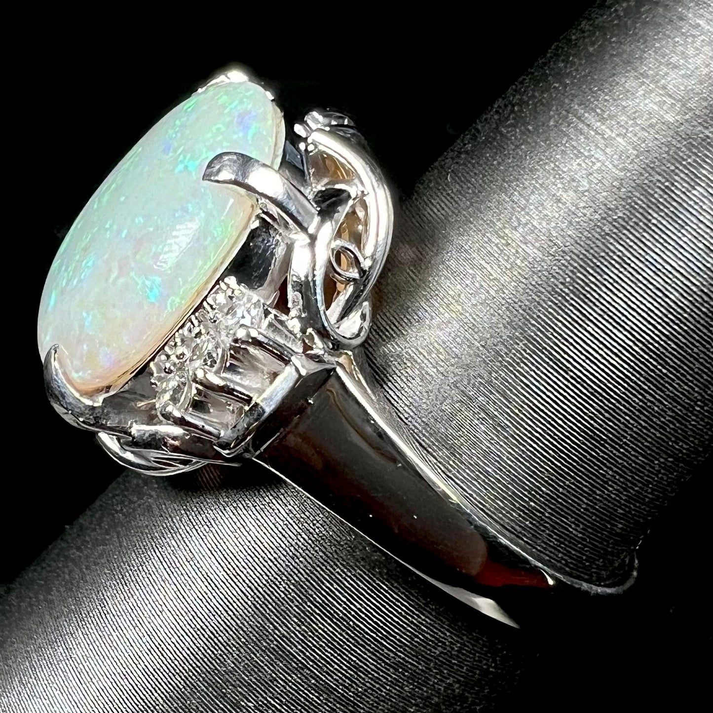 A round cut Australian opal and diamond engagment ring with platinum filigree.