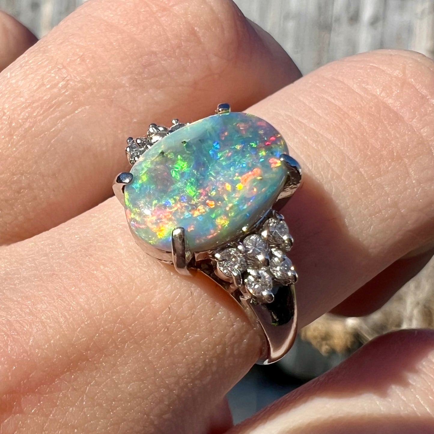 A multicolor Lightning Ridge opal and diamond-accented ring in platinum.