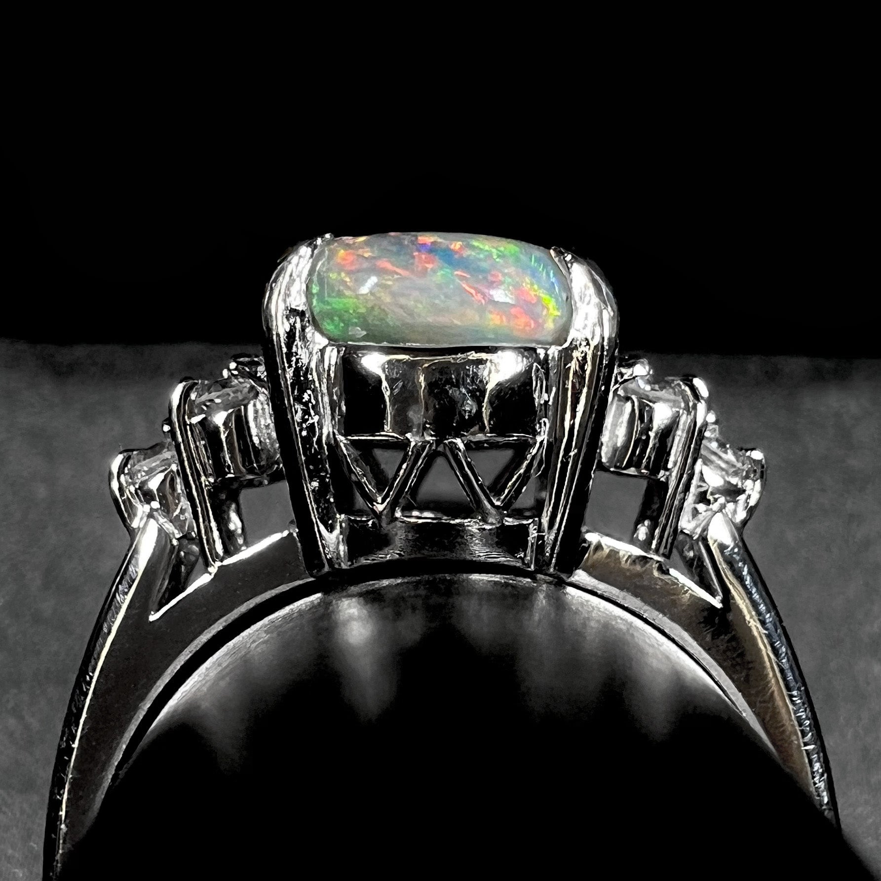 A multicolor Lightning Ridge opal and diamond-accented ring in platinum.