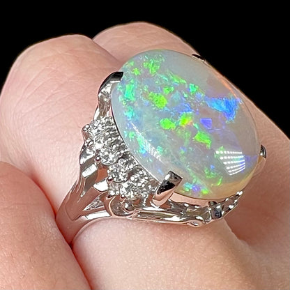 A platinum filigree ring set with a large, green-blue Mintabie crystal opal and diamonds.