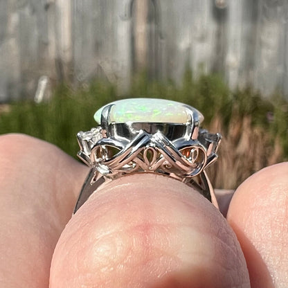 A round cut Australian opal and diamond engagment ring with platinum filigree.