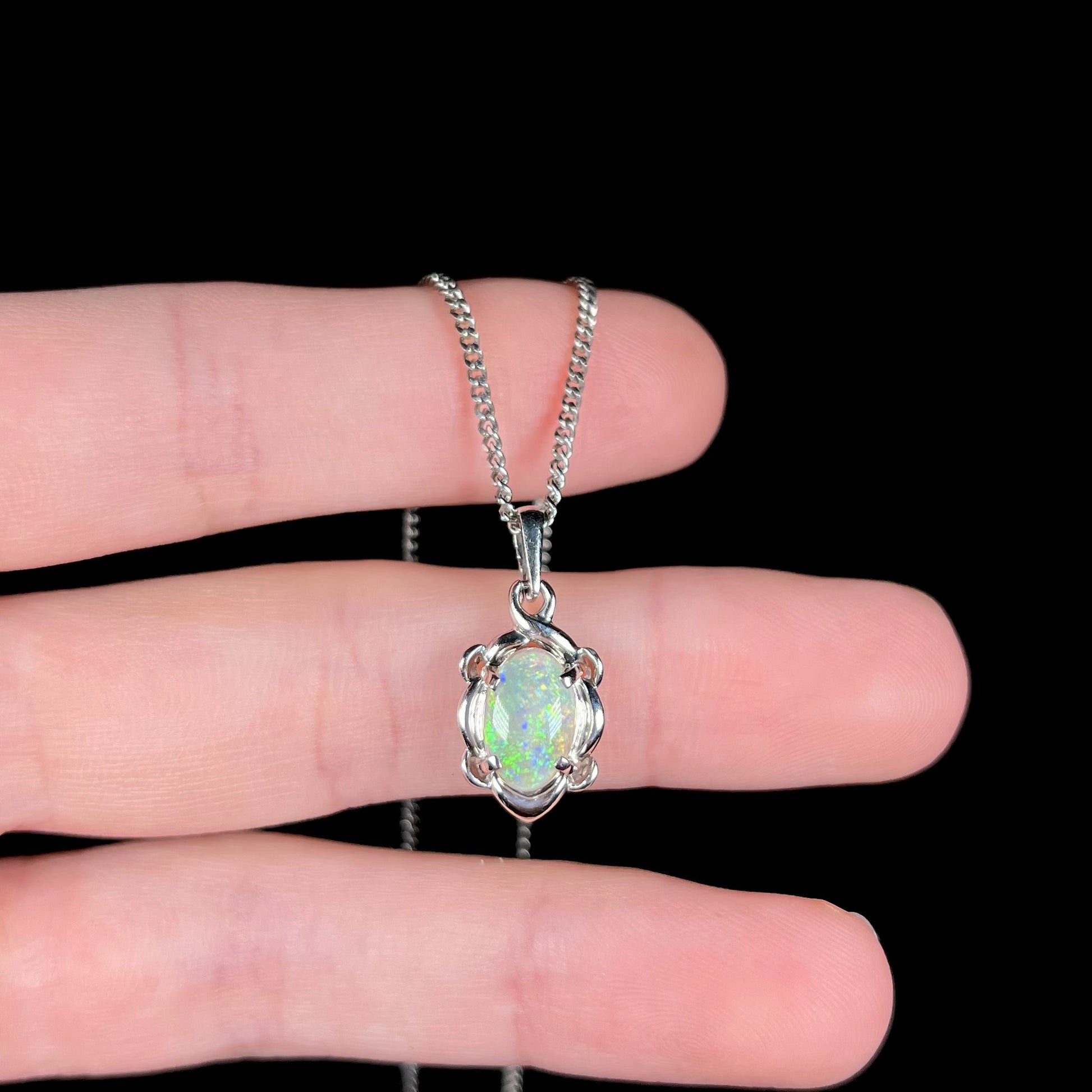 A platinum opal necklace on a platinum chain.  The opal weighs 1.49ct and has predominantly green color play.