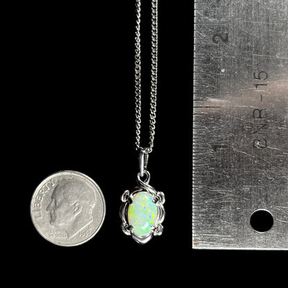 A platinum opal necklace on a platinum chain.  The opal weighs 1.49ct and has predominantly green color play.