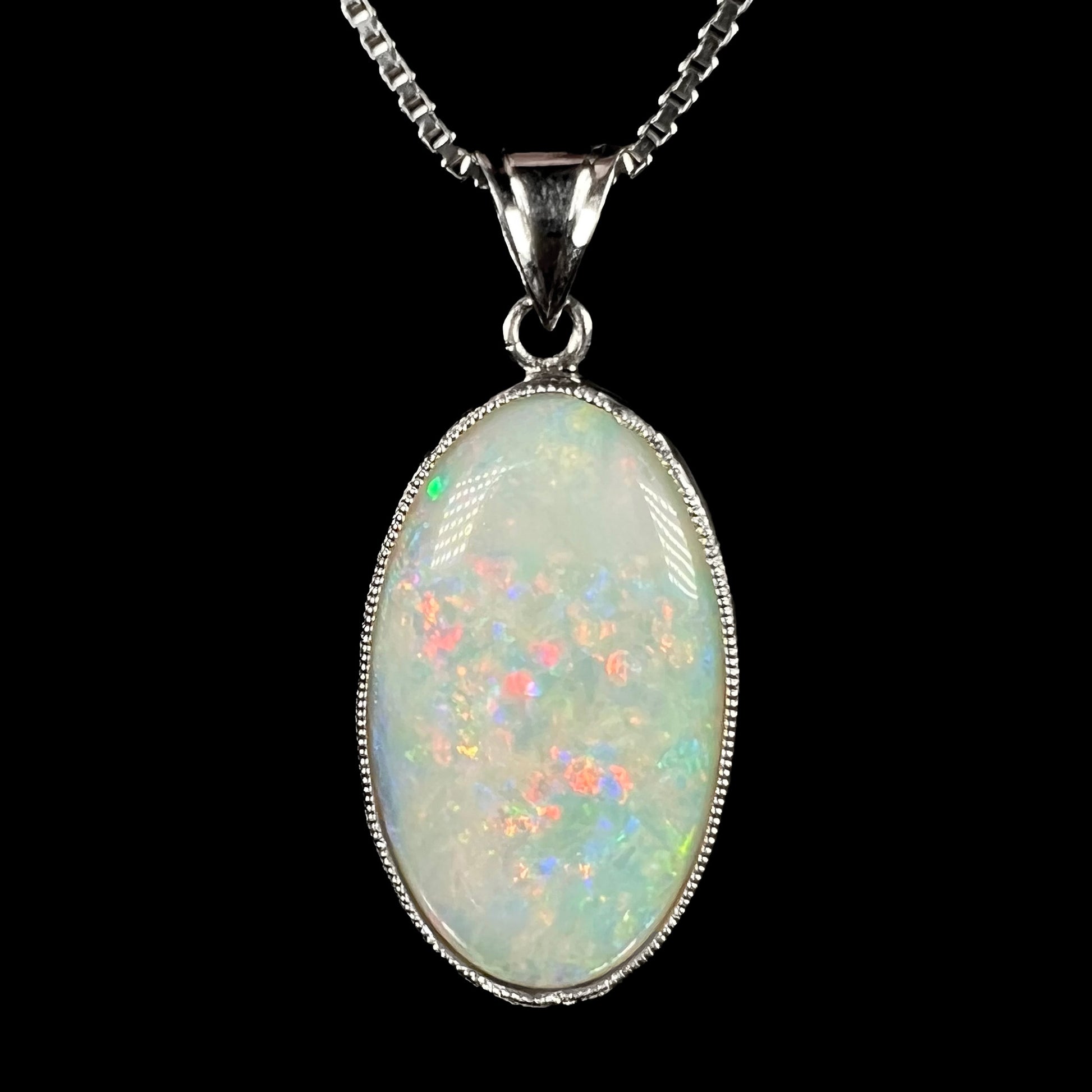 A platinum pendant mounted with an oval cut Australian white opal.