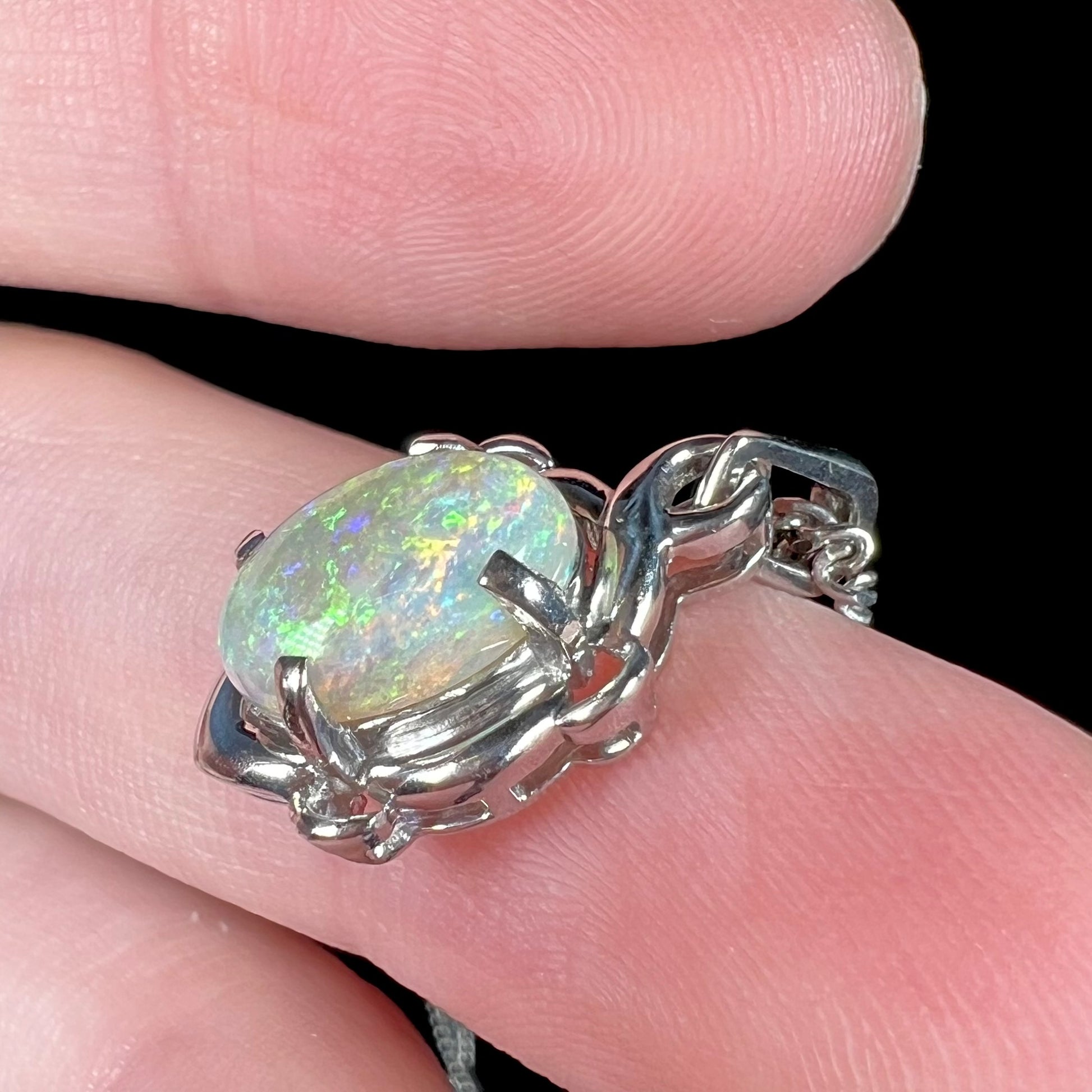 A platinum opal necklace on a platinum chain.  The opal weighs 1.49ct and has predominantly green color play.