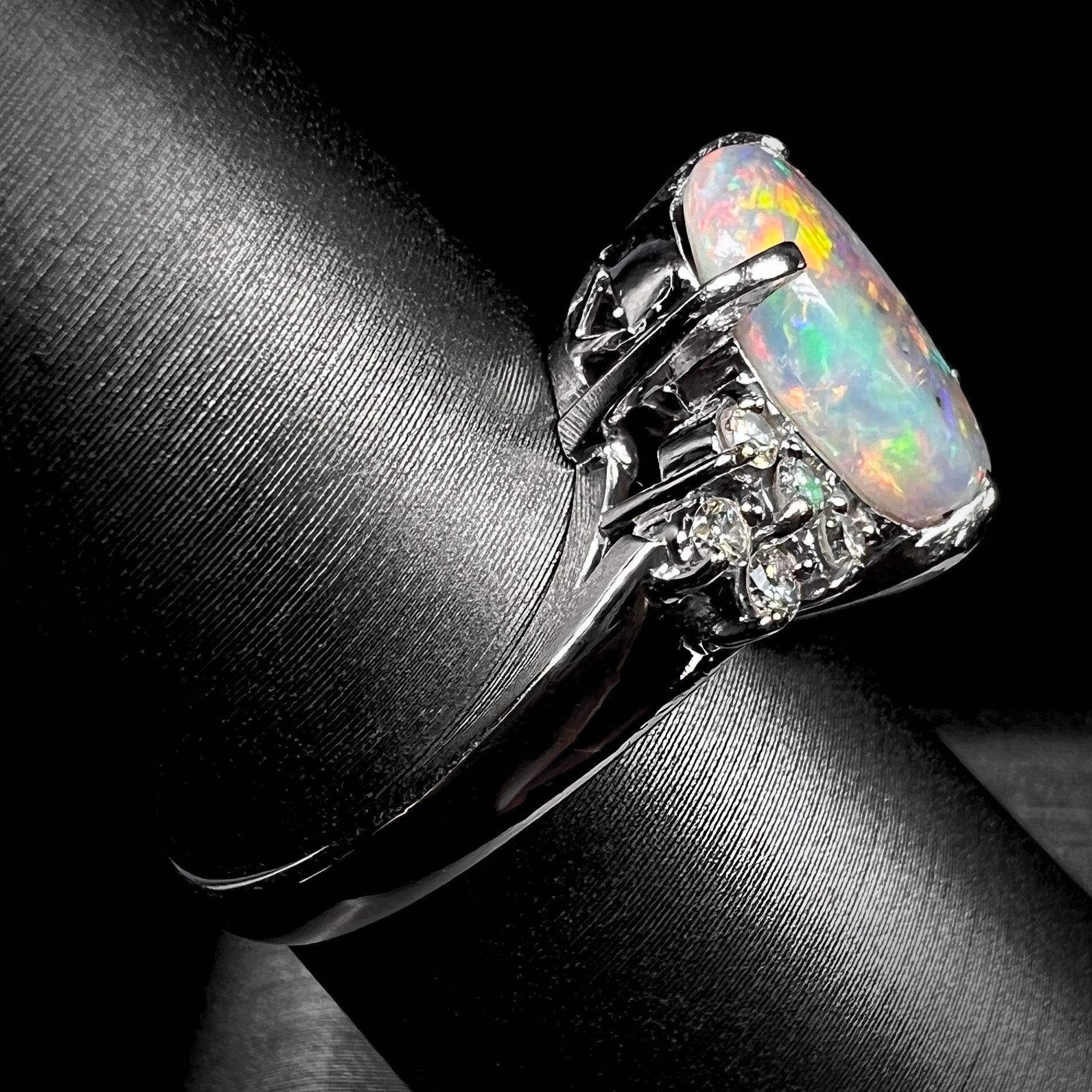 A multicolor Lightning Ridge opal and diamond-accented ring in platinum.