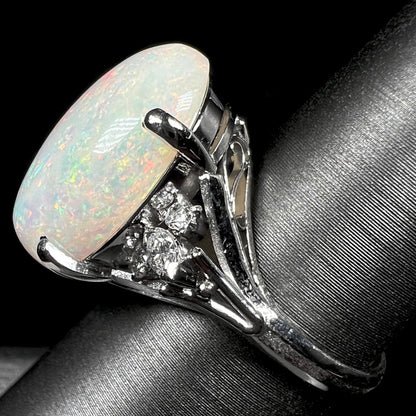 A platinum statement ring mounted with a 7.97ct Coober Pedy opal and marquise cut diamond accents.