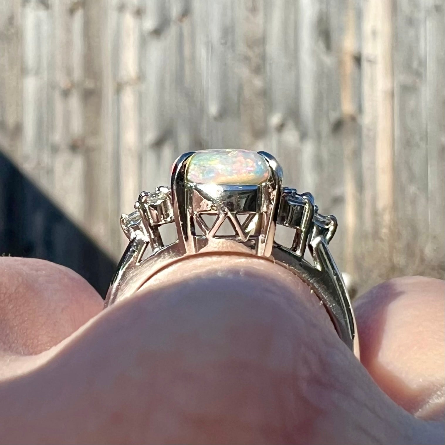 A multicolor Lightning Ridge opal and diamond-accented ring in platinum.