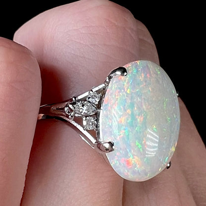 A platinum statement ring mounted with a 7.97ct Coober Pedy opal and marquise cut diamond accents.