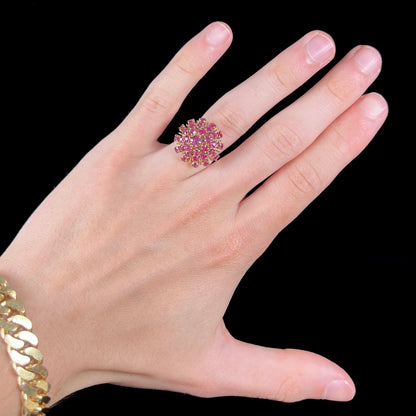 A ladies' vintage Thai princess ring set with round cut purplish red rubies.