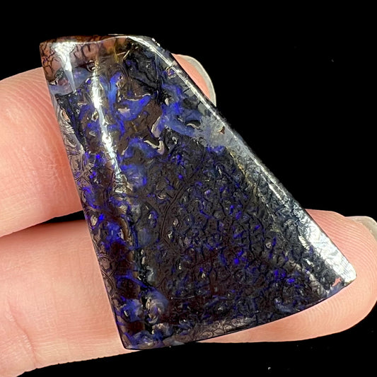 A loose boulder opal with prurple color play and hematite patterning from Koroit, Australia.