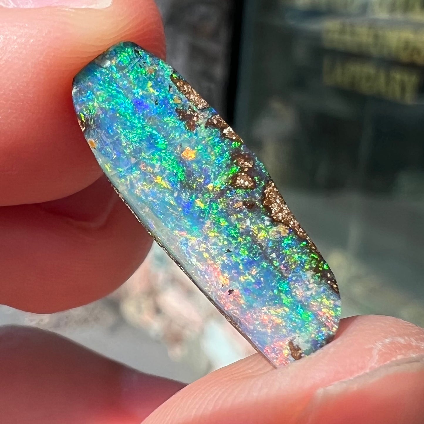 A loose, vivid boulder opal stone from Quilpie, Australia.