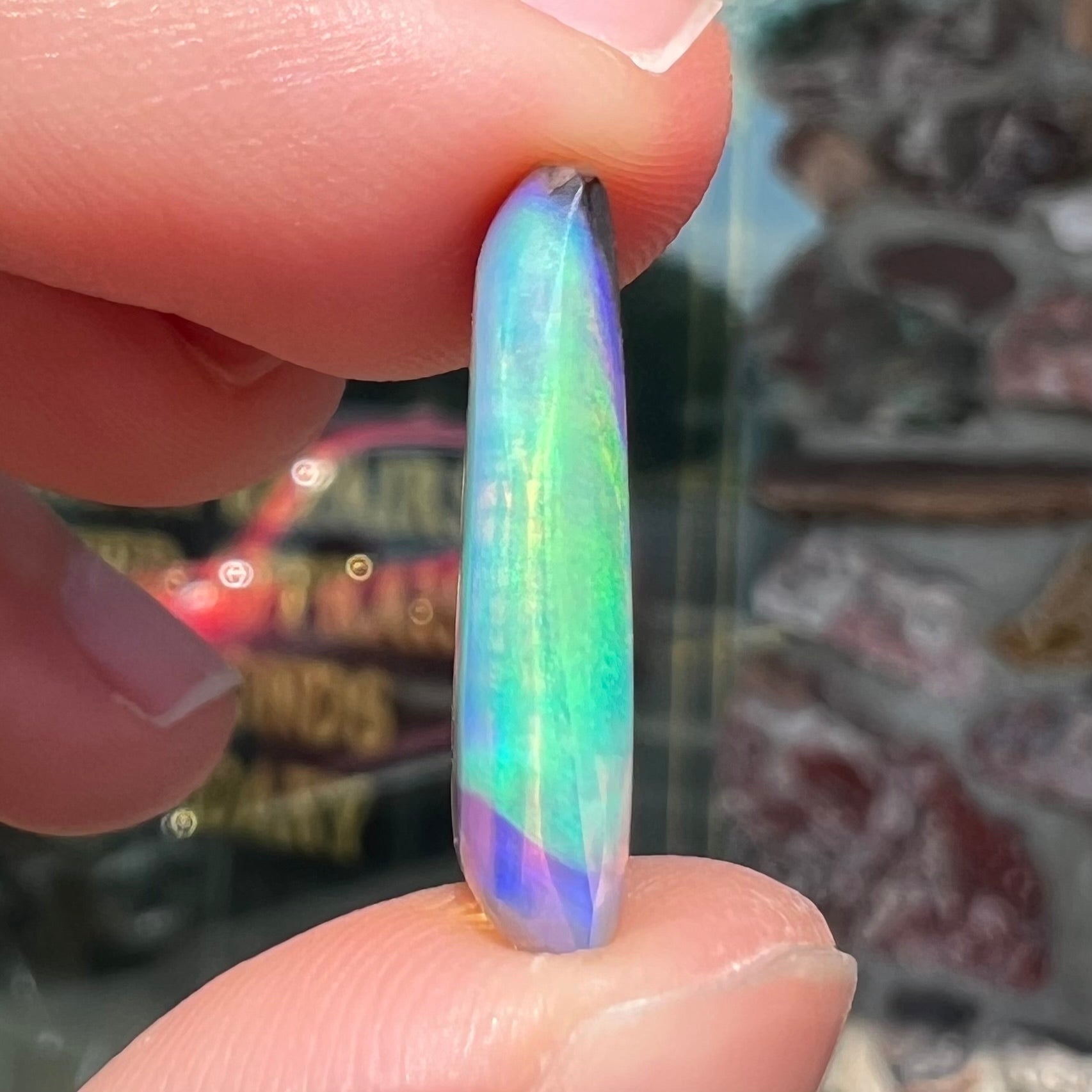 A 6.32ct Brazilian opal stone.  The opal has a green and blue rain pattern.