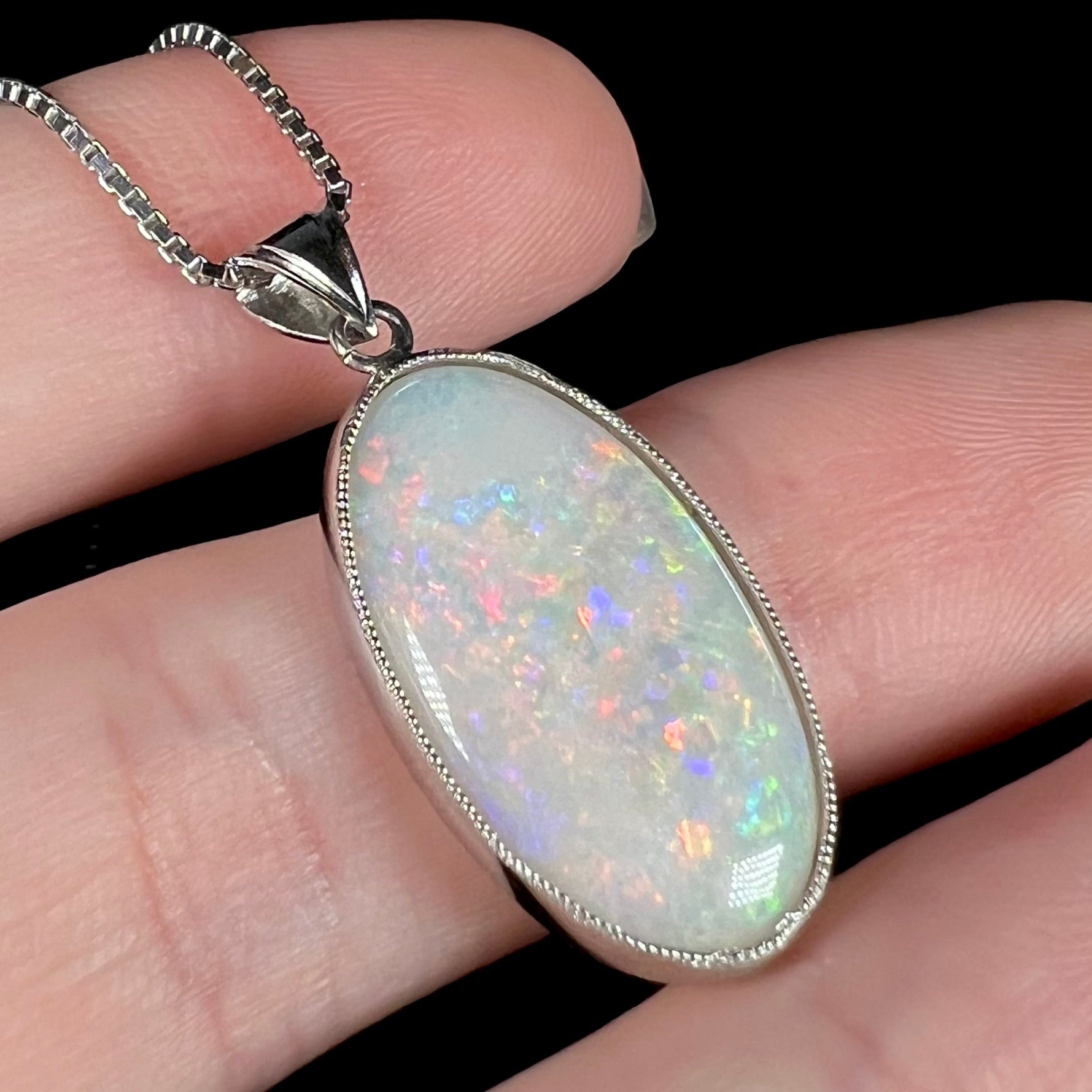 A platinum pendant mounted with an oval cut Australian white opal.