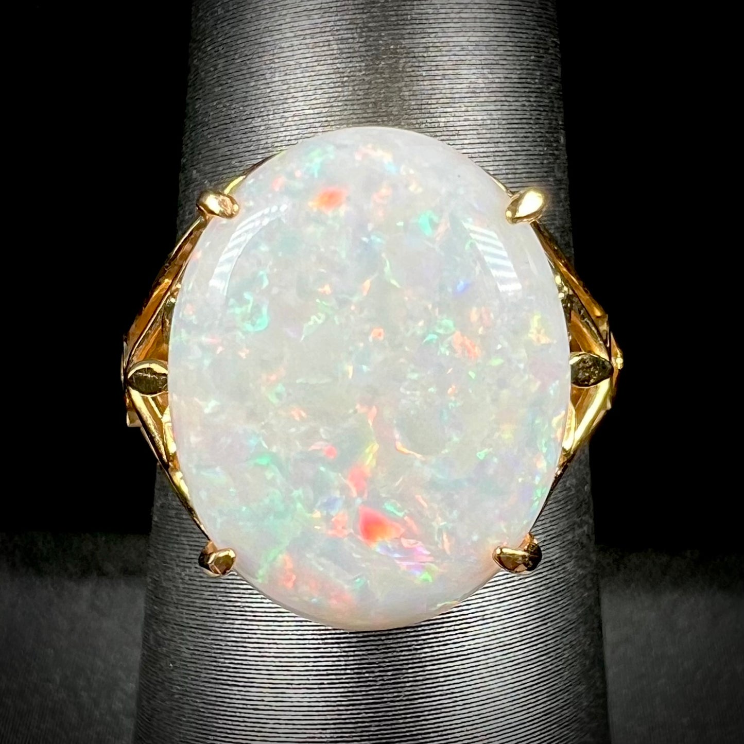 A yellow gold solitaire cocktail ring mounted with a natural white opal from Coober Pedy, Australia.