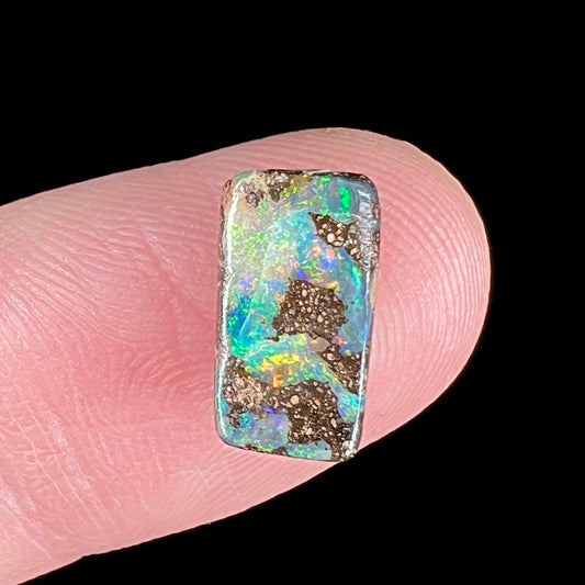 A loose, rectangular boulder opal stone from Quilpie, Australia.
