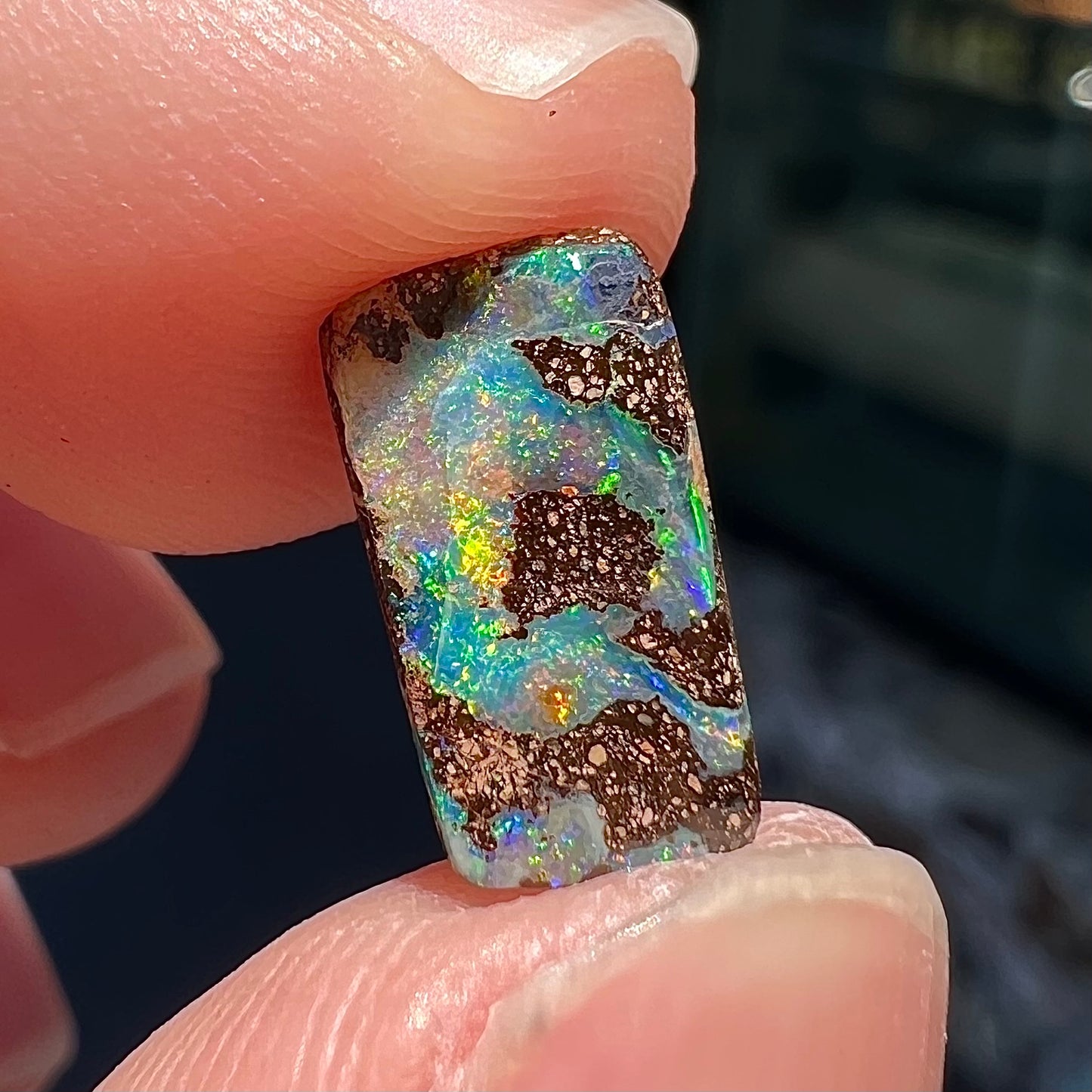 A loose, rectangular boulder opal stone from Quilpie, Australia.