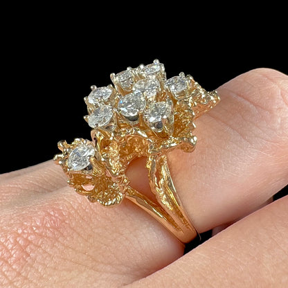 A ladies' 1950's style yellow gold and diamond cluster ring.  The ring is shaped like a leaf with 10 round diamonds set in it.