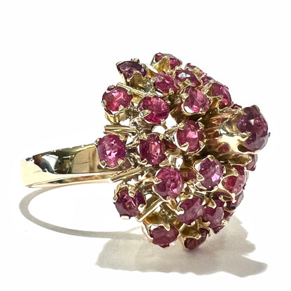 A ladies' vintage Thai princess ring set with round cut purplish red rubies.