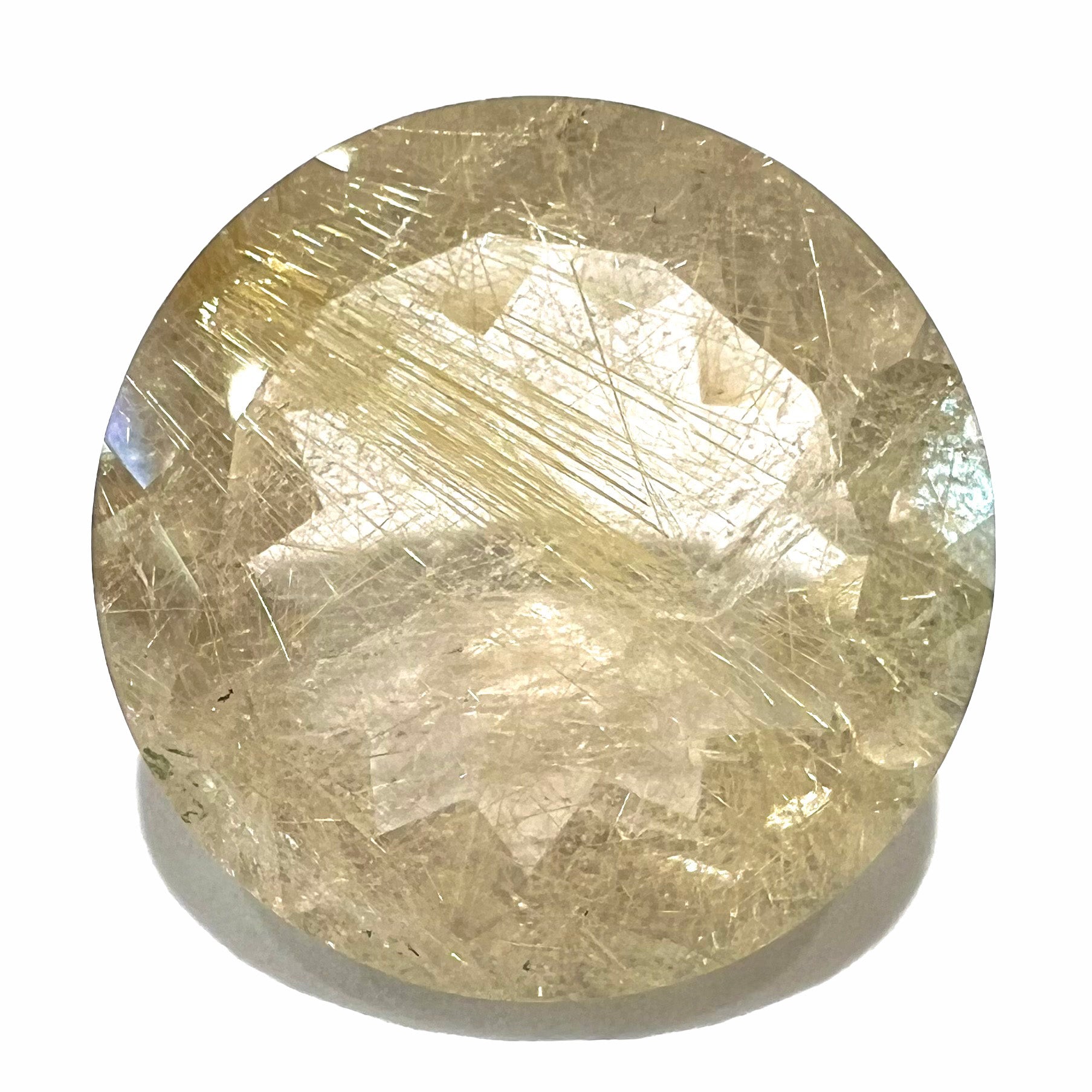 A loose, modified Early American round cut rutilated quartz gemstone.  The rutile inclusions are a golden color.